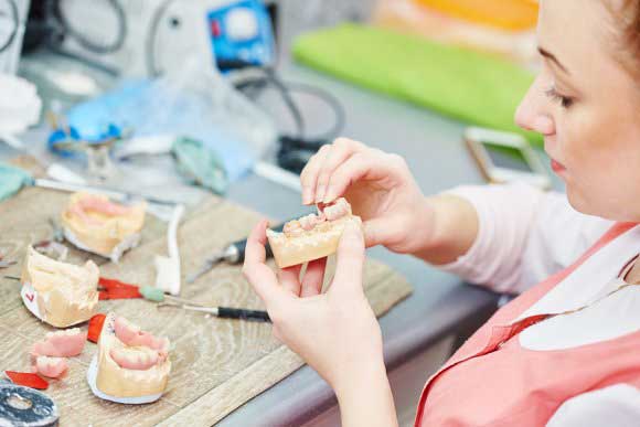 Dental professional checking dental bridge