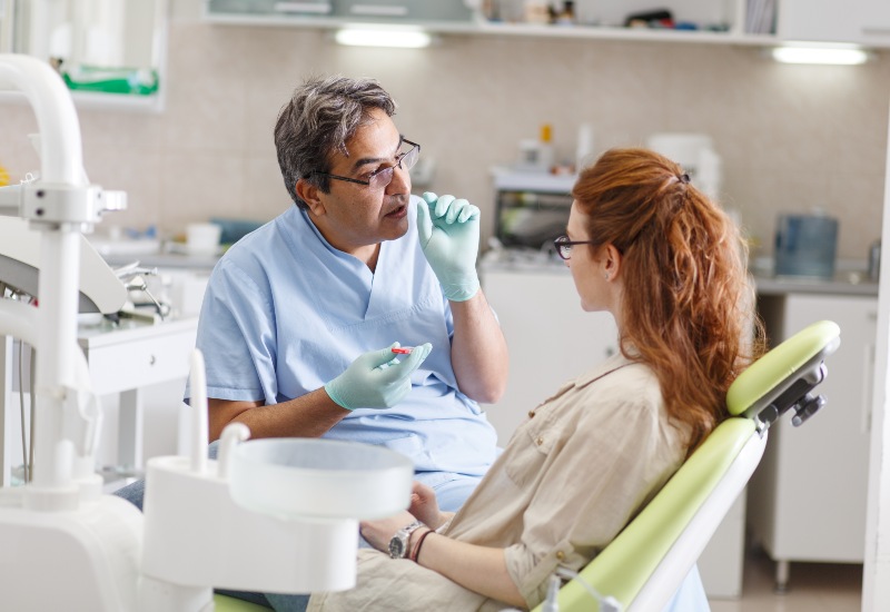 Dentist chatting with patient in Westlake, OH, office about dental treatment options.