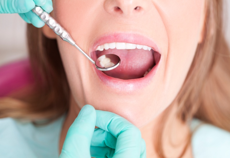 Dentist examining decayed teeth in Westlake, OH