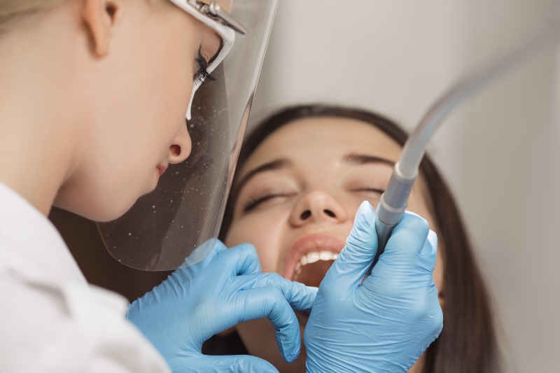 Precise dental bonding procedure on the patient's teeth by a dentist in Westlake, OH